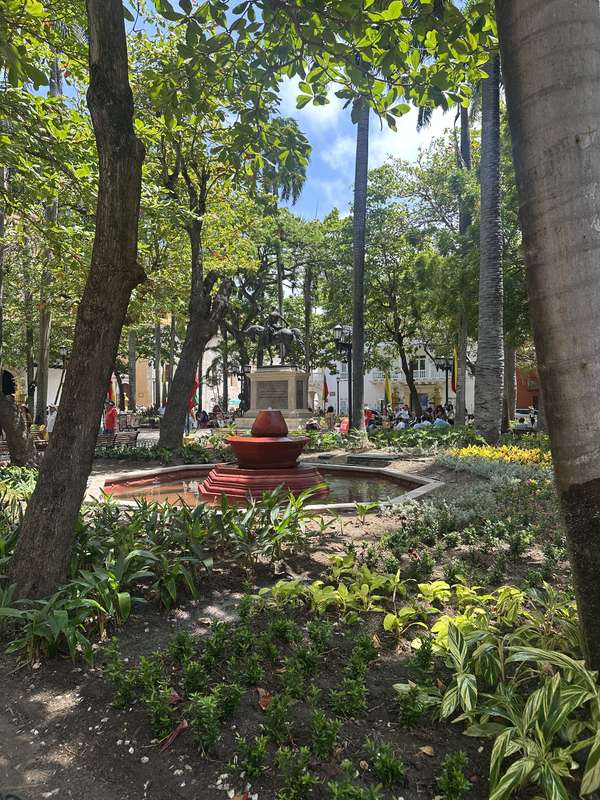 Parque Bolívar — roter Brunnen, tropische Gärten