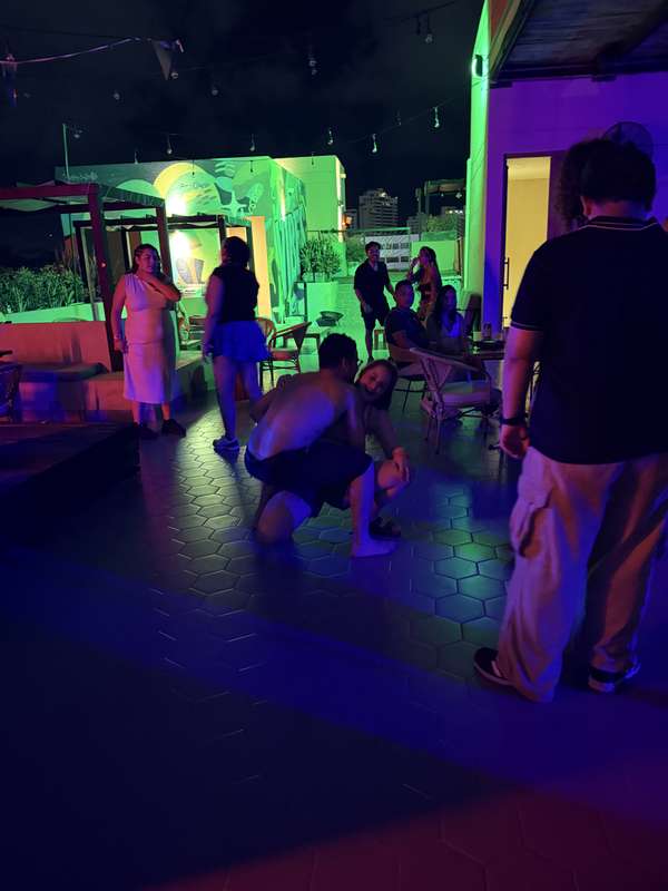 Hostel Rooftop Party bei Nacht, Neonlichter