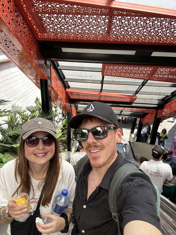 Couple-Selfie an den Rolltreppen, Drinks in Hand