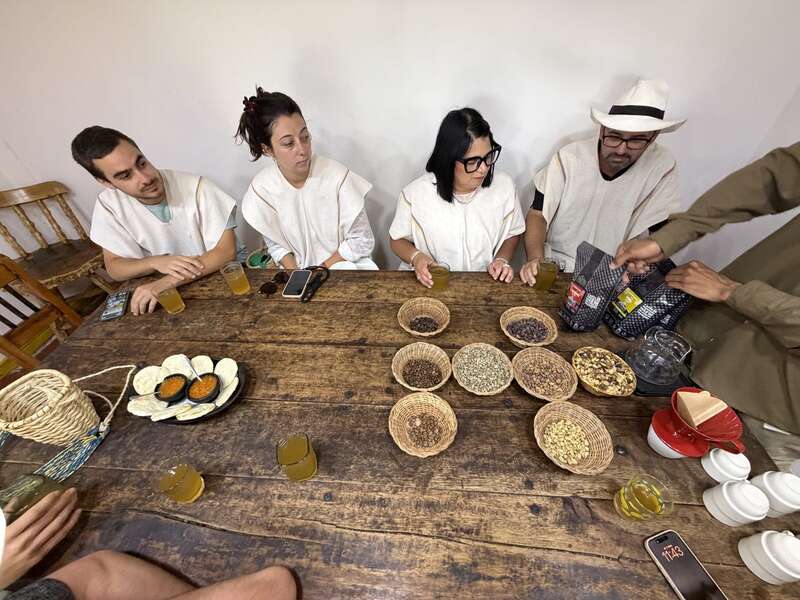 Kaffeeverkostung — alle mit Ponchos am Tisch